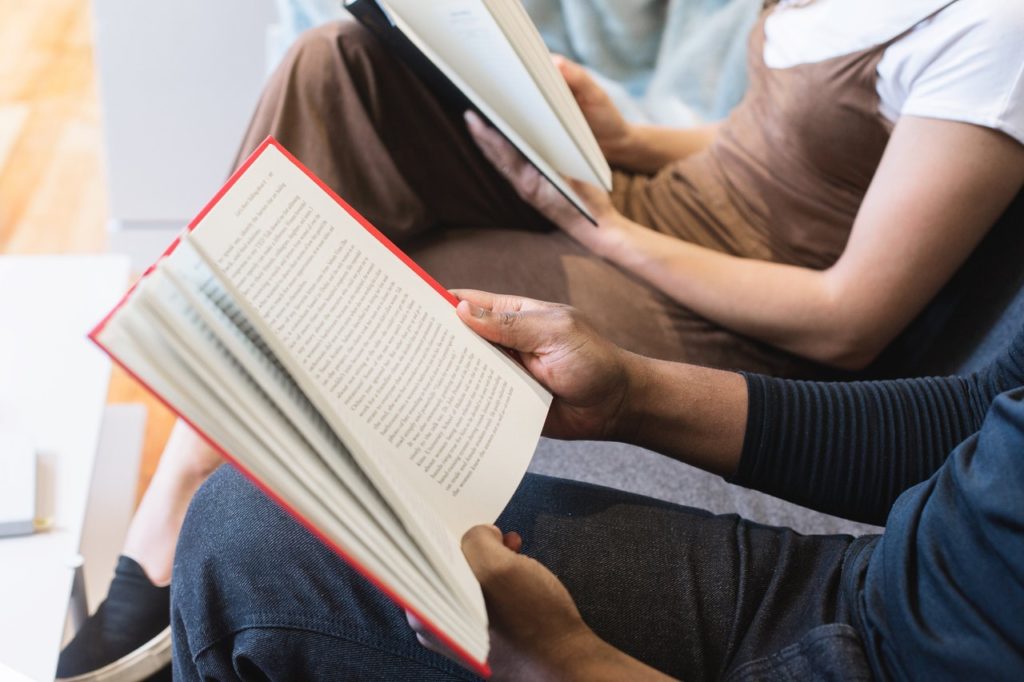 Two people reading books together