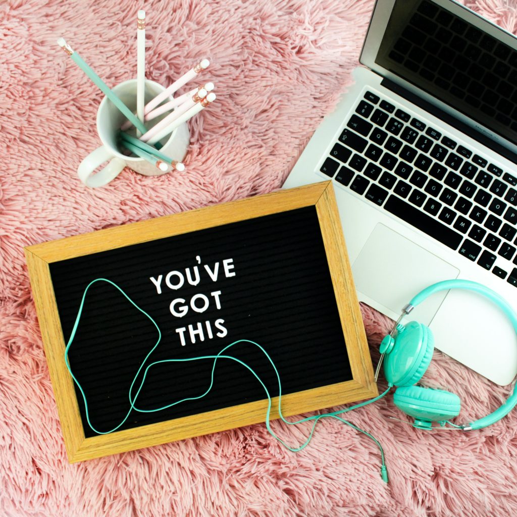 Tutors International one-to-one online private tuition: 'you've got this' text written on a tablet next to a laptop, pens, and headphones